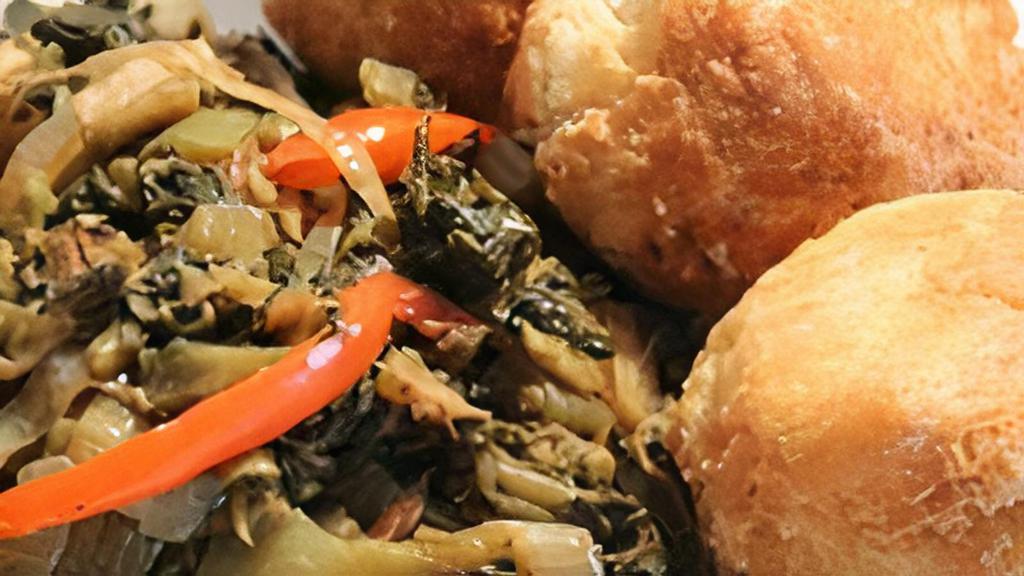 Callaloo & Saltfish · -Jamaican spinach with salt cod sautéed with onions, scotch bonnet peppers, tomatoes and spices.