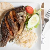 Pescado Frito · Tilapia fish or fish of the day, pan fried. Served with rice, beans and salad.