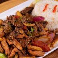 Lomo Saltado Mixto · Traditional Peruvian stir-fry, with seasoned strips of steak and chicken, onions and tomatoe...