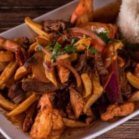 Saltado De Camarones · Traditional Peruvian stir-fry, with shrimps, red onions, and tomatoes. Served with French fr...