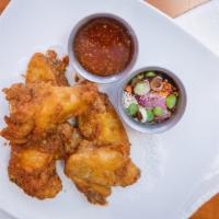 Chicken Wings · Marinated in garlic and pepper, deep-fried and served with sweet chili sauce.