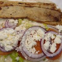 Gyro · Beef or chicken, lettuce, tomato, red onion, feta cheese, Tzatziki sauce in pita bread.