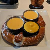 Giant Soft Pretzel · Served with Housemade Beer Cheese, Mustard, and Housemade Jalapeño Caramel Sauce.