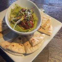 Edamame Hummus · Topped with Madras Spiced Tomatoes and Micro-Green Salad served with Grilled Pita Bread.
