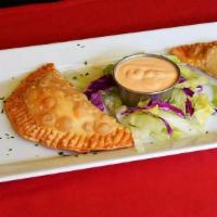 Empanadas · Lightly breaded, flaky pastries stuffed with chicken or ground beef. Served with our special...