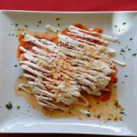 Tamales · Our homemade corn dough with chicken spread on a corn husk, topped with ranchero sauce, sour...