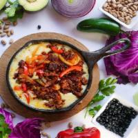 Queso Fundido · Pick from three great choices: chorizo (Mexican sausage), steak, or chicken. Melted Chihuahu...