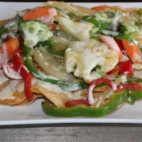 Nachos Vegetarianos · Grilled bell peppers, onions, tomatoes, cauliflower, carrots, and broccoli. Served on a bed ...