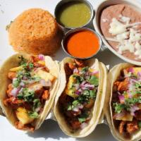 Tacos Al Pastor · This dish was developed by Lebanese immigrants in central Mexico. Three corn tortillas fille...