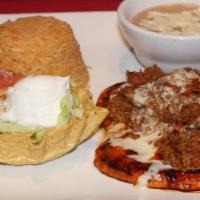 Pollo Con Chorizo · Grilled chicken breast topped with chorizo (Mexican sausage) and cheese dip. Served with ric...