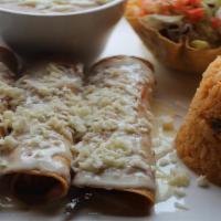 Flautas De Pollo · Four rolled corn tortillas deep fried and stuffed with chicken, topped with nacho cheese. Se...