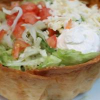 Taco Salad · Crispy flour tortilla with your choice of beef or chicken with beans, lettuce, tomatoes, gua...