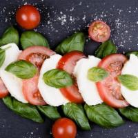 Caprese · Fresh mozzarella, Roma tomatoes and fresh basil served with warm pita bread