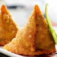 Vegetable Samosa · Crisp, flaky pastry filled with potato and peas, spiced with cumin, turmeric, garam masala a...