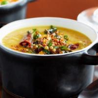 Dal Tadka · Yellow lentils tempered with garlic, ginger and toasted whole red chilis.