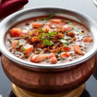 Dal Makhani · Black lentils and red kidney beans cooked slowly with tomato, garlic and butter.