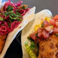 Fish Tacos - Pickled Red Cabbage And Cilantro · Three Fish Tacos; Fried Haddock that's been marinated in a garlic lime sauce.