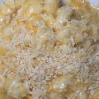 Mac-N-Cheese · Our house cheese sauce tossed with double elbow pasta and finished with a ritz cracker toppi...