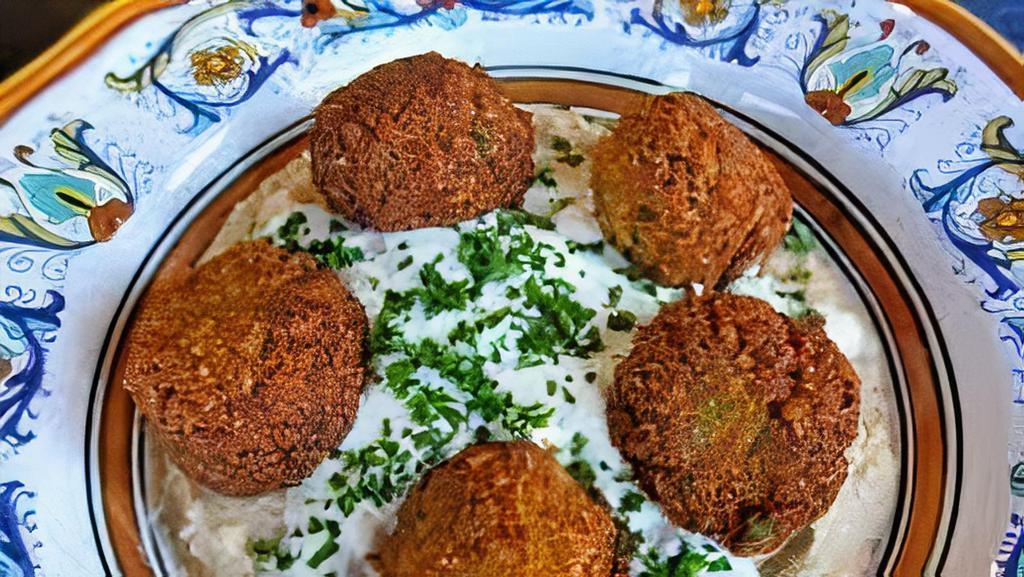 Fried Falafel Cakes With Hummus (5) · Fried ground chickpeas patty.