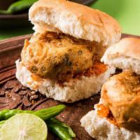 Vada Pav · Spicy potato filling served with toasted pav bread and garnished with mint sauce and spicy g...