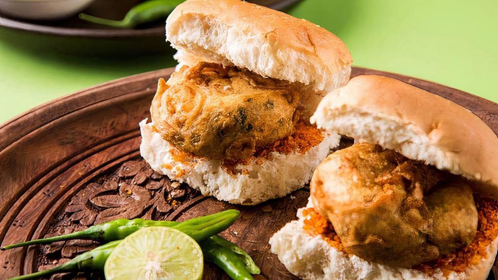 Vada Pav · Spicy potato filling served with toasted pav bread and garnished with mint sauce and spicy garlic.