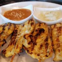 Chicken Satay · Grilled coconut marinated chicken with peanut butter sauce.