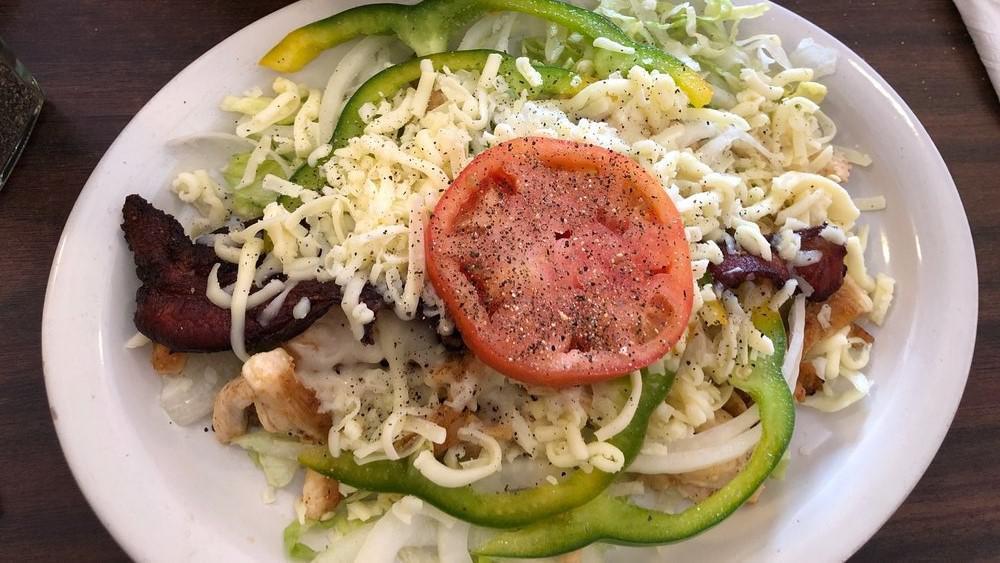 Chicken Salad · Crispy floor shell filled with strips of grilled chicken, bell peppers, lettuce, tomato, onion, bacon, shredded cheese, and choice of dressing.