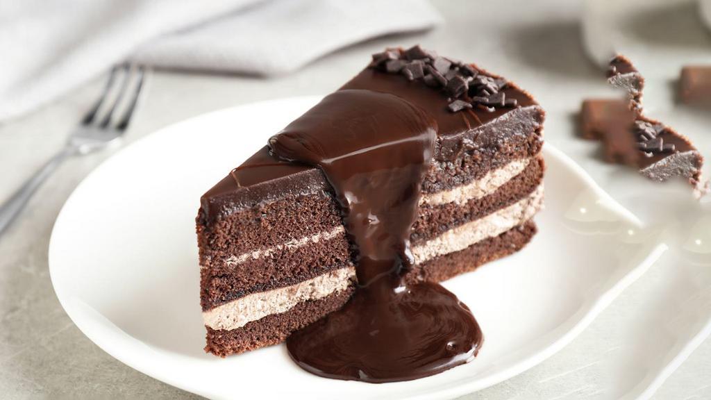Chocolate Cake · Deep, dark, rich two-layer cake, drenched in chocolate syrup and covered with soft, chocolate ganache.