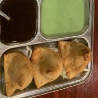 Samosa · Pyramid shaped pastry stuffed with potatoes, green peas and spice (2 pieces).