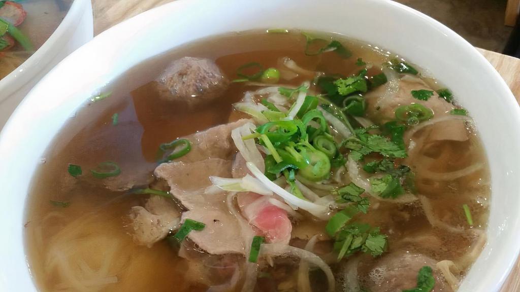 Phở Hải Dương Đặc Biệt · House special beef noodle soup - rare steak, well-done brisket, flank, fatty brisket, tendon, tripe, and beef meatballs.
