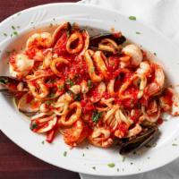 Seafood Bella Napoli · Clams, mussels, shrimp, crabmeat, calamari and scallops in a fresh marinara sauce over lingu...