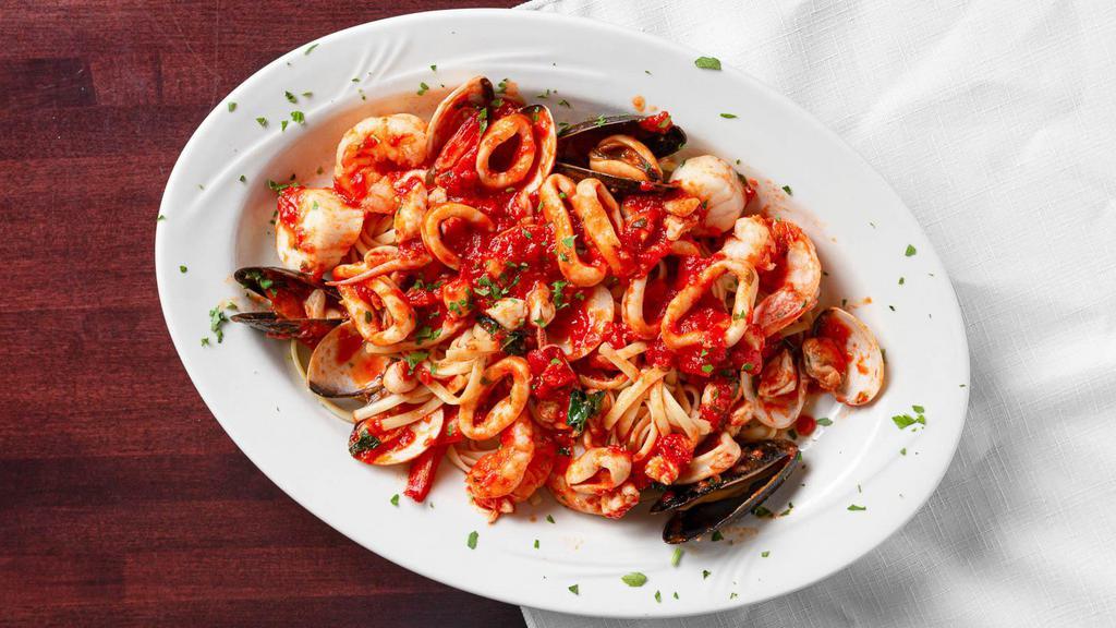 Seafood Bella Napoli · Clams, mussels, shrimp, crabmeat, calamari and scallops in a fresh marinara sauce over linguine.
