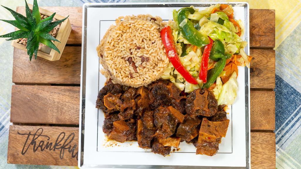 Oxtail · comes with rice and peas, and vegetables.