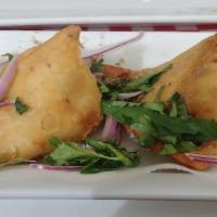 Samosa · Crispy fried pastry filled with potatoes and green peas flavored with fresh spices.