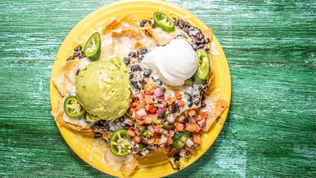 Black Bean Nachos · Vegetarian. Tortilla chips topped with black beans, jack cheese, pico de gallo, fresh jalapeños and sour cream. Add guacamole ,avocado  for an additional charge.