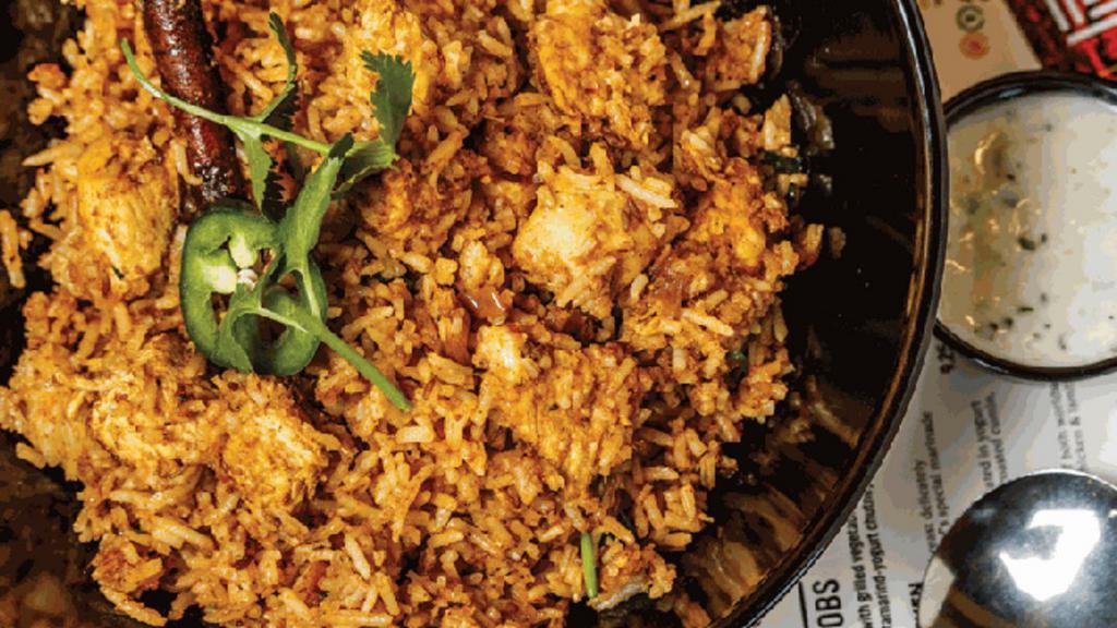 Chicken Biryani (Gf) · Basmati Rice stir fried with chicken, garlic, ginger, onion, and whole spices. Served with yogurt blended with roasted cumin, seasoning and finely minced vegetables.