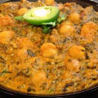 Saag Channa (Gf) · A flavorful combination of our garbanzo bean curry & pureed spinach sautéed with garlic & on...