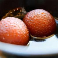 Gulab Jaman · A traditional deep fried milk pastry served warm in a rosewater-honey syrup.