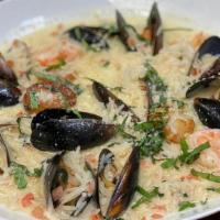Mediteranean Mussels · Black mussels, simmered with garlic, shallots in a butter-basil sauce with white wine, tomat...