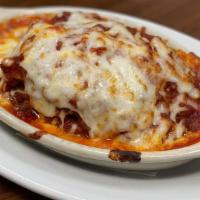 Meat Lasagna · An Italian classic! Layers of chunky meat sauce, creamy ricotta, and sheets of pasta baked w...