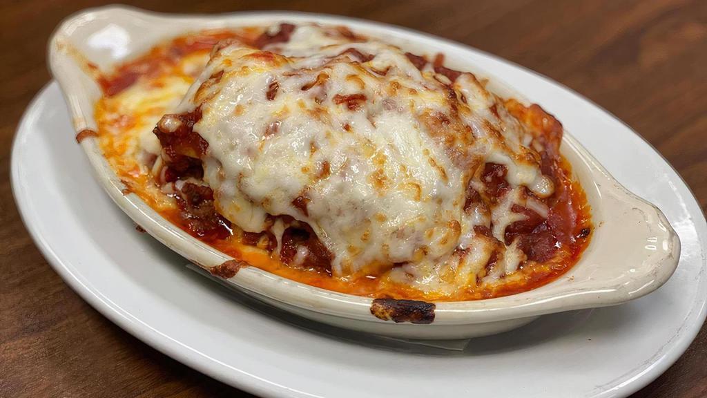 Meat Lasagna · An Italian classic! Layers of chunky meat sauce, creamy ricotta, and sheets of pasta baked with mozzarella cheese.