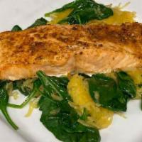 Baked Salmon Filet · Atlantic salmon seasoned and baked to perfection. Served over sauteed baby spinach and serve...