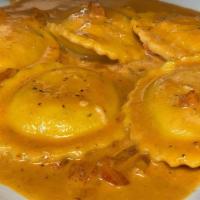 Lobster Ravioli · Ravioli filled with lobster meat, sauteed with garlic, shallots, diced tomatoes and simmered...