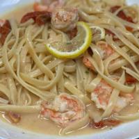Shrimp Scampi · Shrimp sauteed in garlic, white wine in a light cream lemon-butter sauce with sundried tomat...