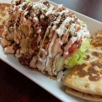 The Wedge · Served with pita bread. A wedge of crispy iceberg lettuce, topped with chopped tomatoes, bac...
