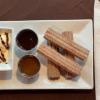 Churros · Cinnamon covered Churros with Apple filling. A side of icecream and chocolate drizzle.