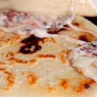 Pupusa Revuelta · Filled with cheese, pork, beans served with coleslaw