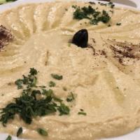 Hummus · Ground chick peas mix with tahini sauce and spices, served with pita bread. Vegetarian.