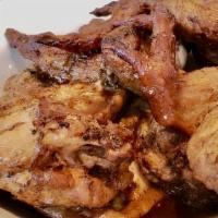 Jerked Chicken Jamaican Style 1/2 Chicken · Tender and flavorful caribbean-style slow-roasted chicken with jerk seasoning served with ri...