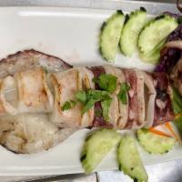 Grilled Octopus · Seasoned whole octopus sliced and grilled. Served with zesty Thai dressing.